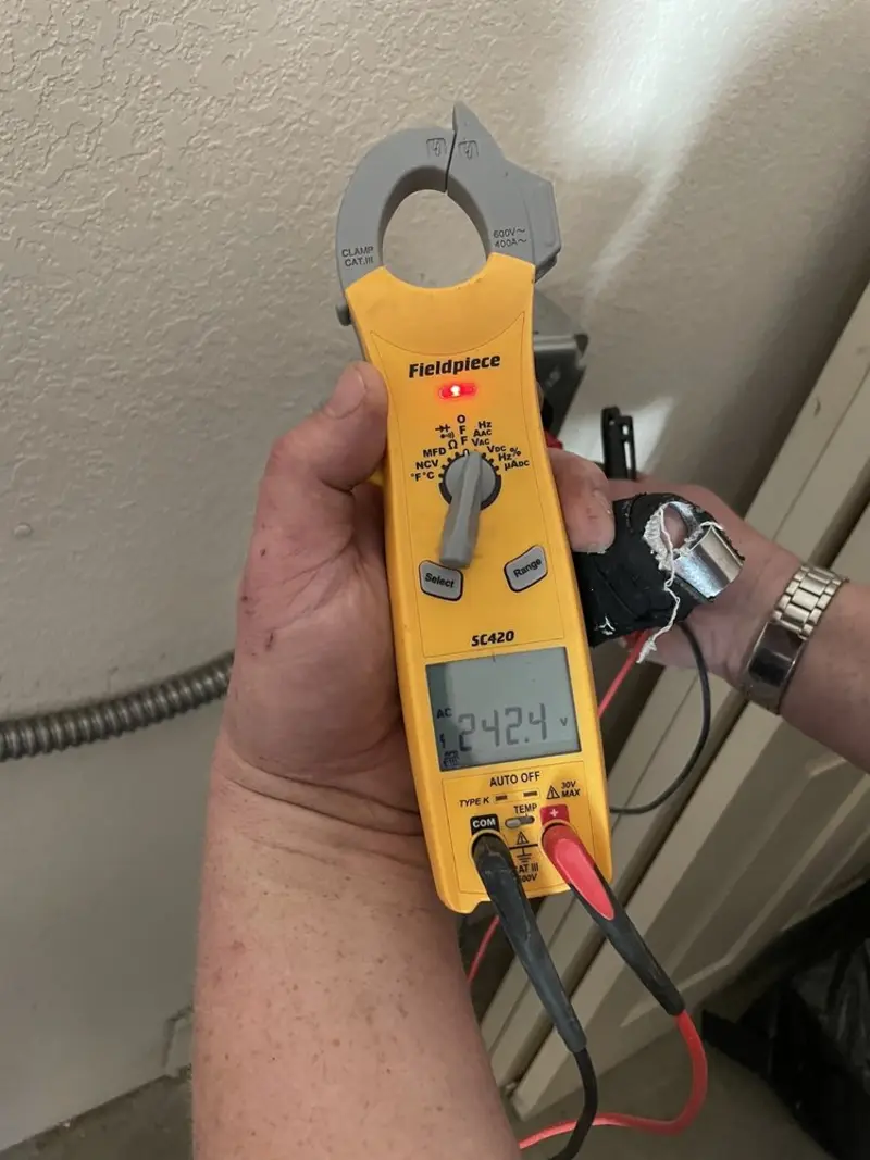 Voltage testing with clamp meter during Ceiling Fan Installation in Fort Carson
